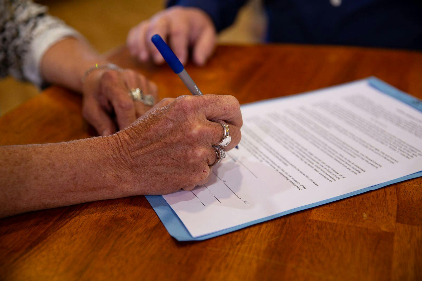 Close-up of woman hand signing documents